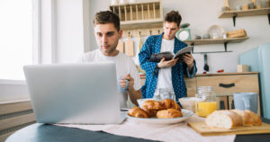 Image of two men in a kitchen at a computer